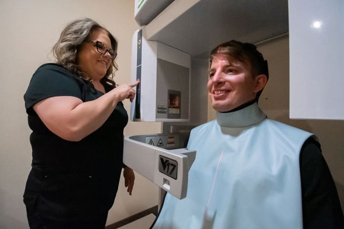 dental assistant talking to a patient at our Forney dental office.