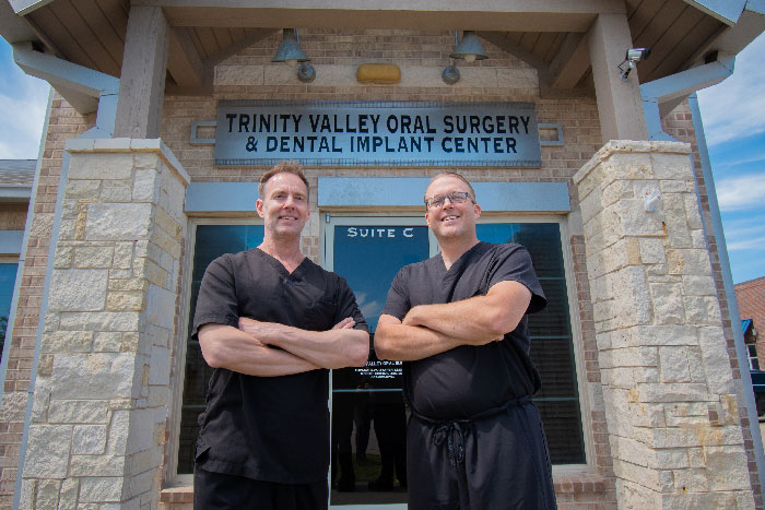 Dr. Reed Gibbins and Dr. Thomas Draper in front of their Forney dental office, TRINITY VALLEY ORAL SURGERY & DENTAL IMPLANTS.