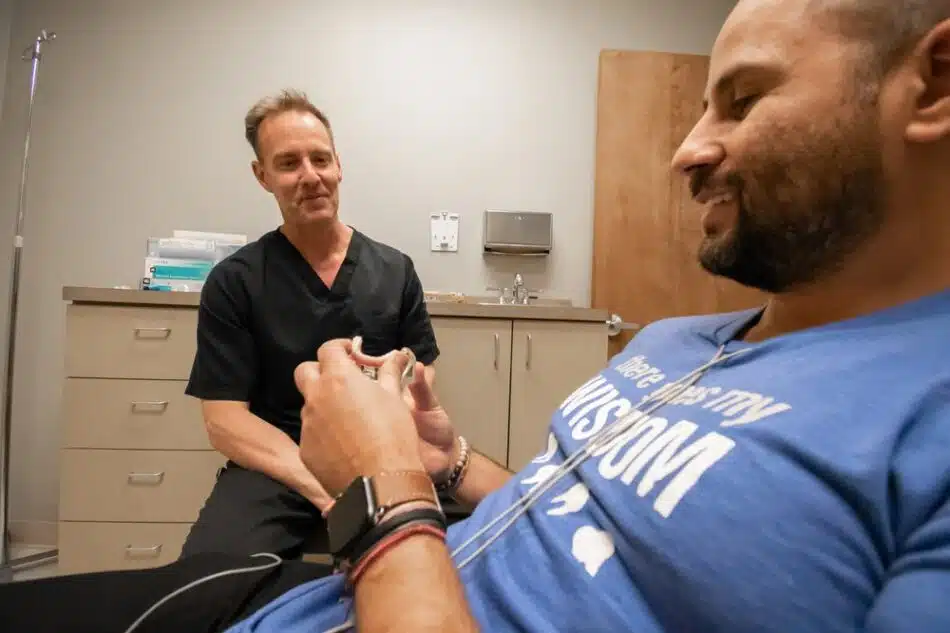 A patient looking at a snap on dentures with our oral surgeon in Forney, TX